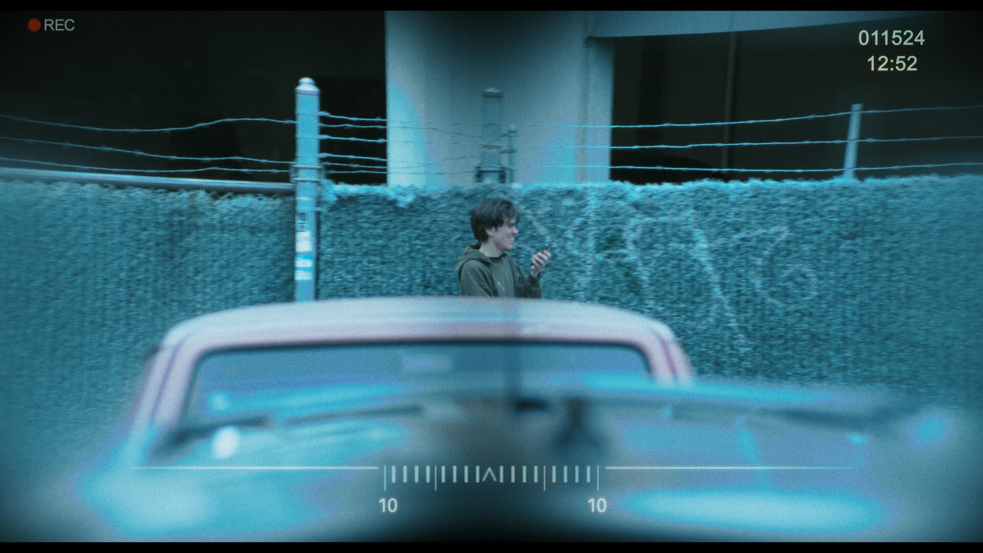 WFTW still 2 The antagonist of Working for the Weekend, as viewed through a set of binoculars across from across the street.